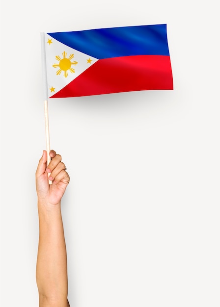 Person waving the flag of Republic of the Philippines