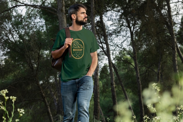 Person wearing mock-up t-shirt outdoors in nature