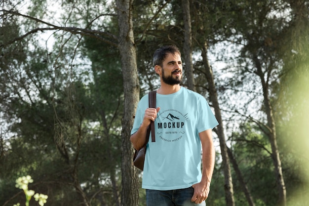 Person wearing mock-up t-shirt outdoors in nature