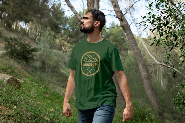 Person wearing mock-up t-shirt outdoors in nature