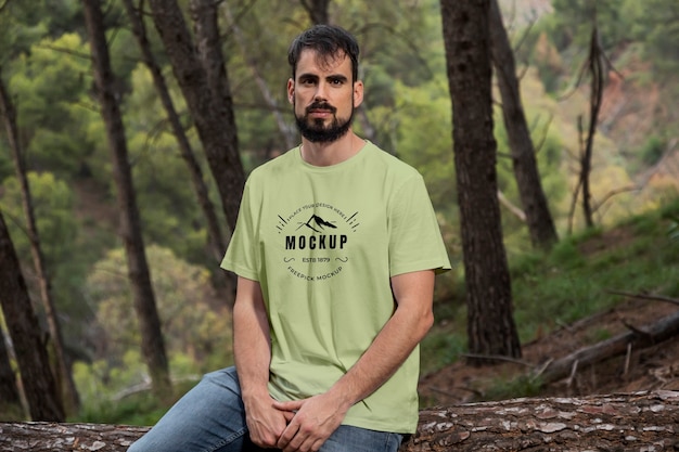 Person wearing mock-up t-shirt outdoors in nature