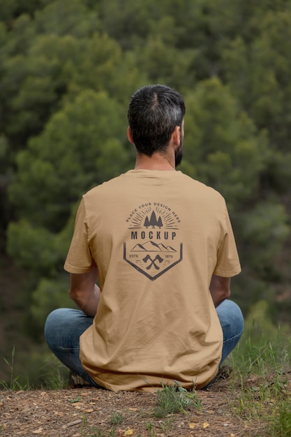 Person wearing mock-up t-shirt outdoors in nature