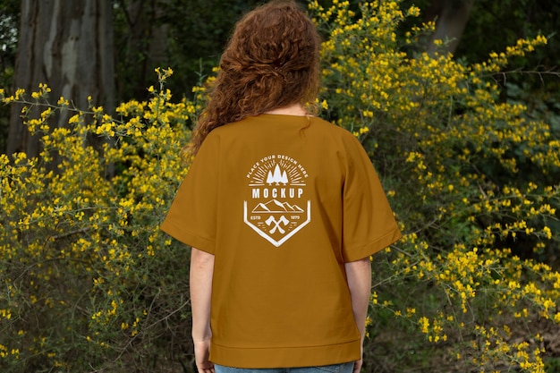 Person wearing mock-up t-shirt outdoors in nature