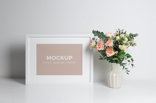 Photo or picture frame mockup in minimalistic interior with flowers bouquet