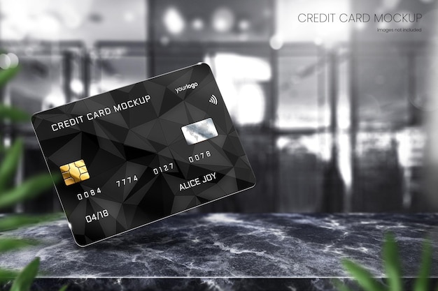 Photorealistic credit card mockup design on black marble tabletop with bright bokeh in background