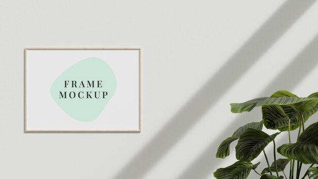 Picture frame mockup on the interior wall with plant