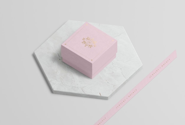 Pink jewelry box on marble with golden symbol