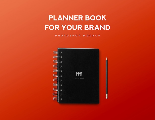 Planner book for your brand and black pencil on red background