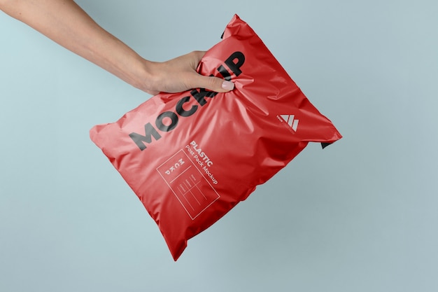 Plastic post pack mockup held in hands