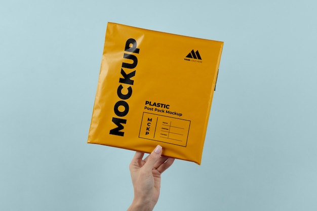 Plastic post pack mockup held in hands