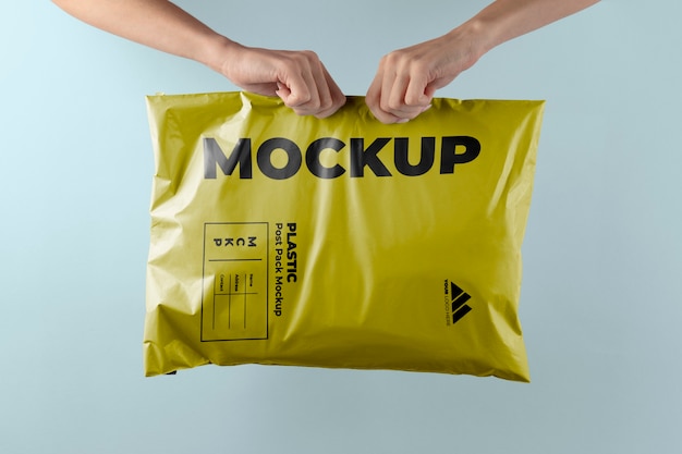 PSD plastic post pack mockup held in hands