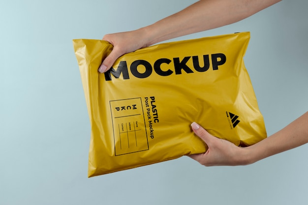 PSD plastic post pack mockup held in hands