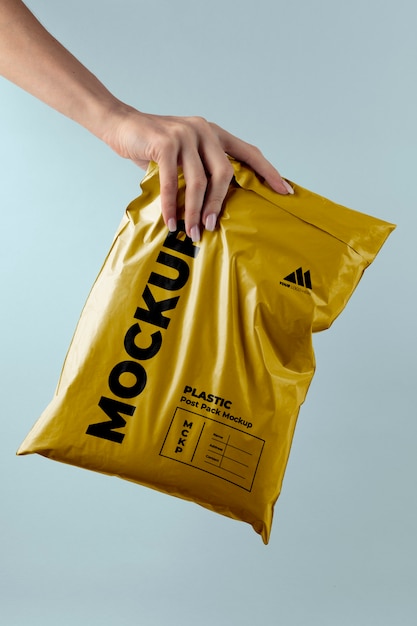 Plastic post pack mockup held in hands