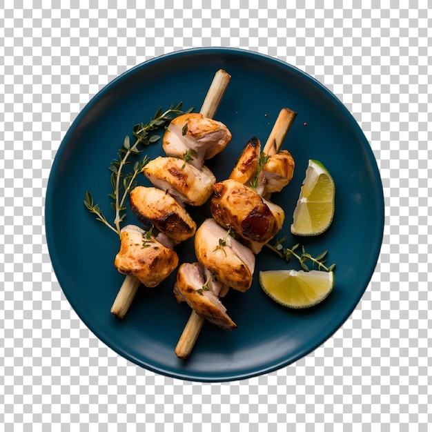 a plate of chicken skewers with lemon slices on it