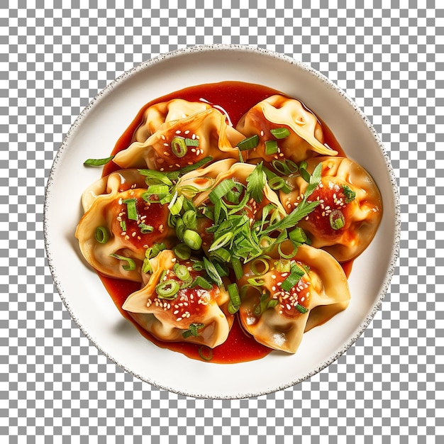 Plate of dumplings with green onions and a red sauce on transparent background