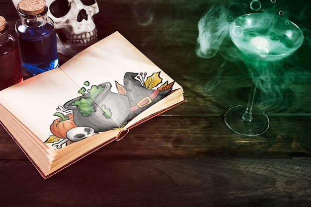 Poisonous drink and open book with halloween drawing