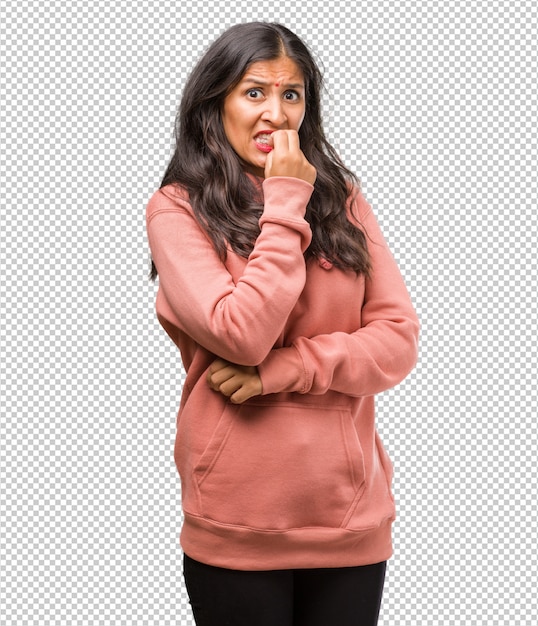 Portrait of fitness young indian woman biting nails, nervous and very anxious and scared for the future, feels panic and stress