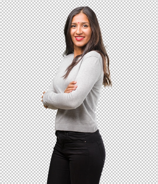 Portrait of young indian woman crossing his arms, smiling and happy, being confident and friendly