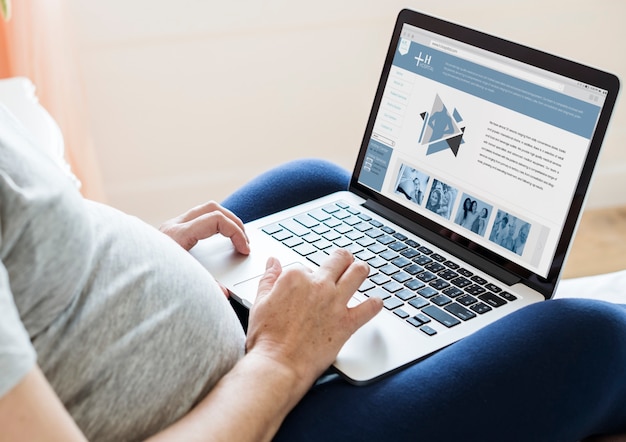 Pregnant woman using computer laptop