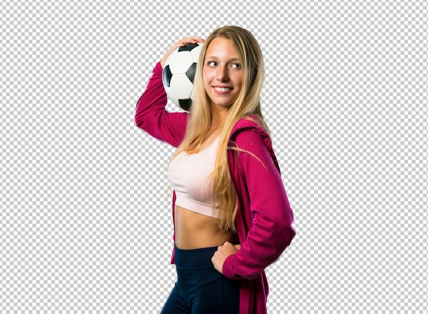 Pretty sport woman holding a soccer ball