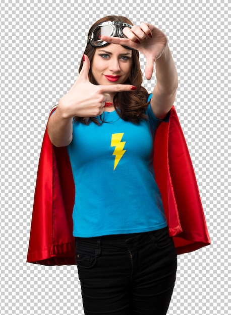 Pretty superhero girl focusing with her fingers