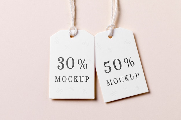 Price tag with discount  on pink background flat lay