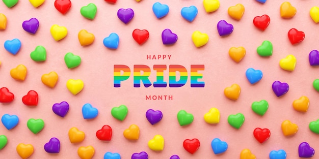 Pride banner with rainbow colored hearts on pink background and copy space for LGBTQIA Pride month