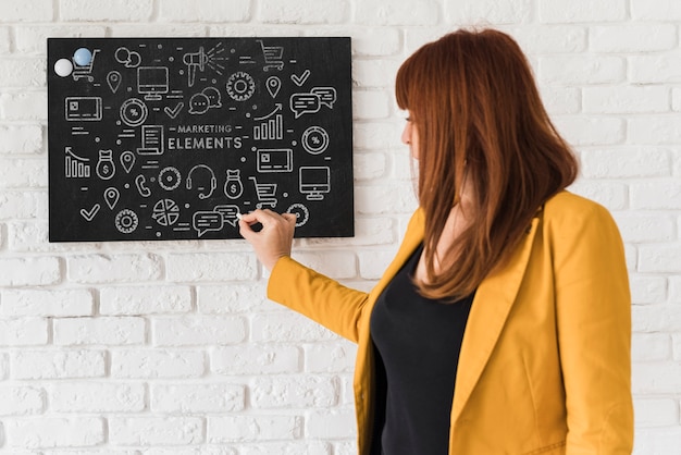 PSD professional woman writing on blackboard