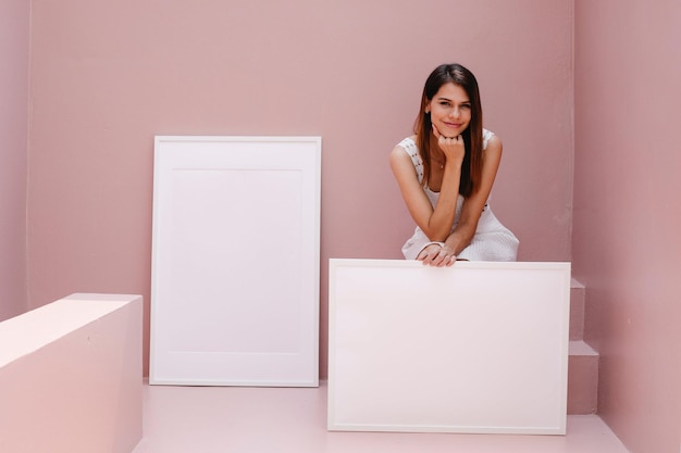 PSD White Frame held by a woman with a pink background