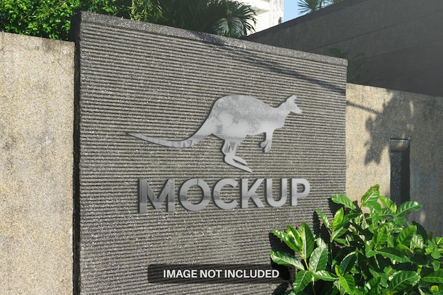 Realistic 3d metal logo mockup on the outdoor wall