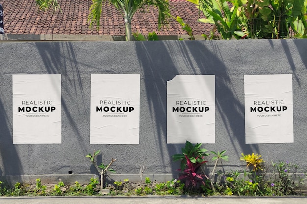 Realistic 4 outdoor poster mockup on villa wall premium psd