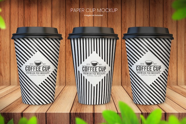 PSD realistic paper coffee cup mockup of three cups on wooden background