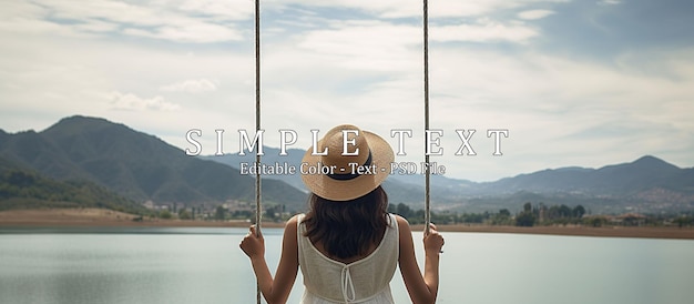 Rear view of woman in hat sitting on swing against lake and mountain landscape