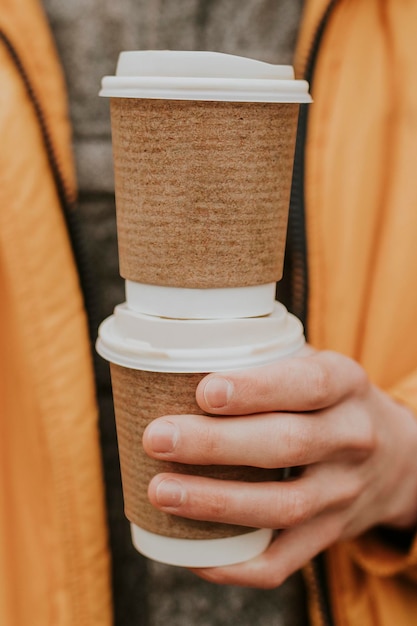 PSD recycled coffee cups mockup psd with hand closeup