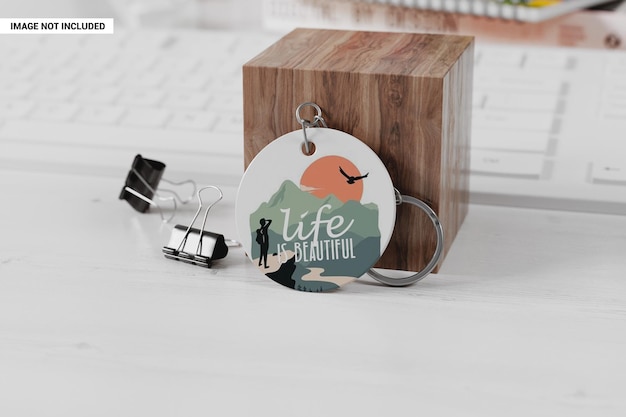 Round plastic keychain near wooden cube mockup