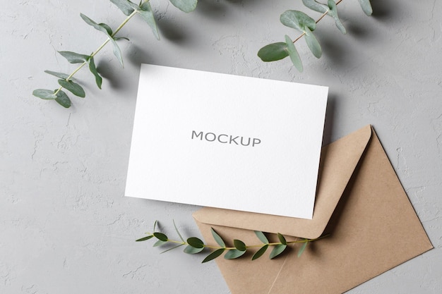 Save the date card or invitation mockup with envelope and fresh eucalyptus twigs