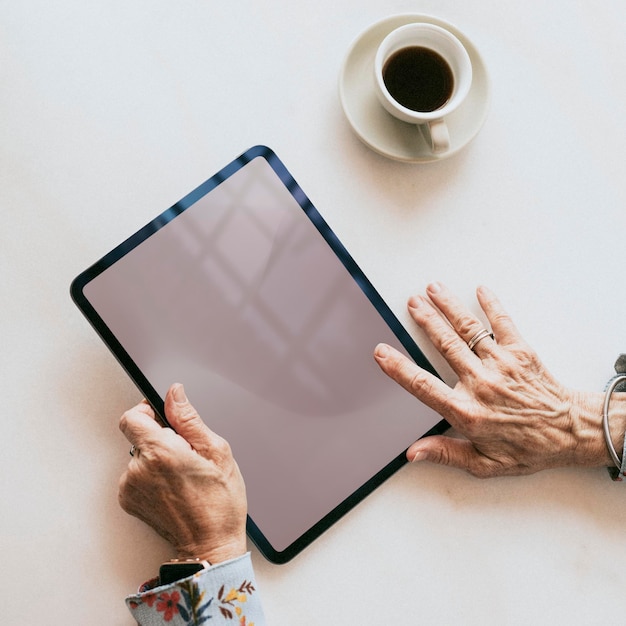 PSD senior woman using a digital tablet mockup