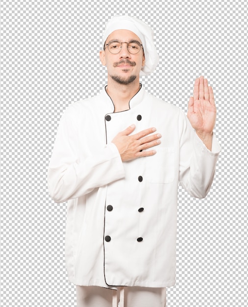 PSD serious young chef with a gesture of oath