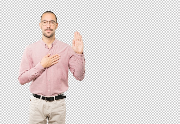 Serious young man with a gesture of oath