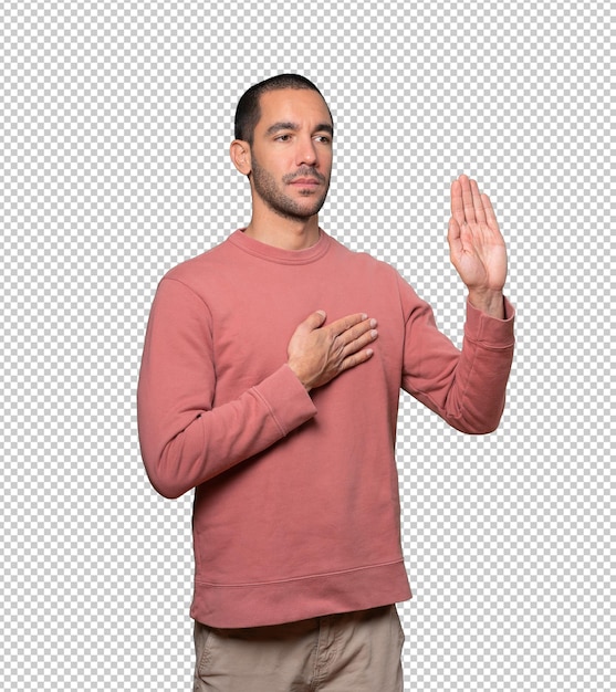 Serious young man with a gesture of oath