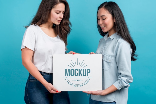 Side view girls holding board mock-up