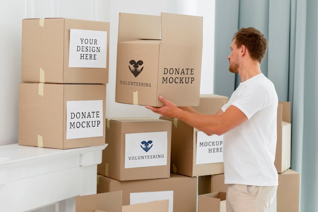 Side view of male volunteer with donation boxes