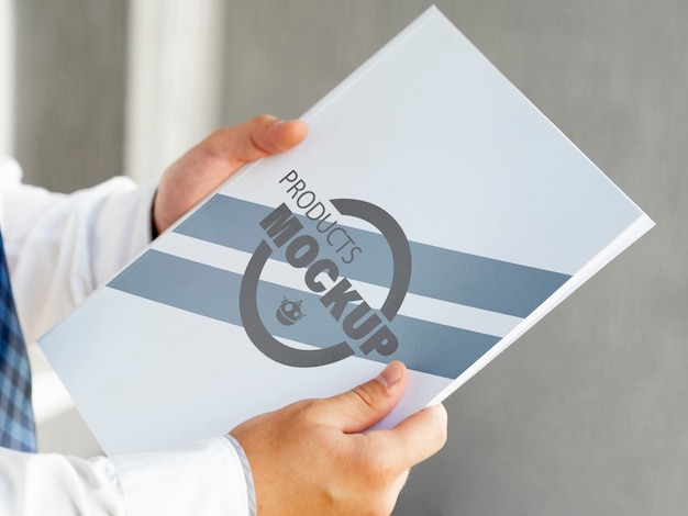 Side view man holding a notebook mock-up