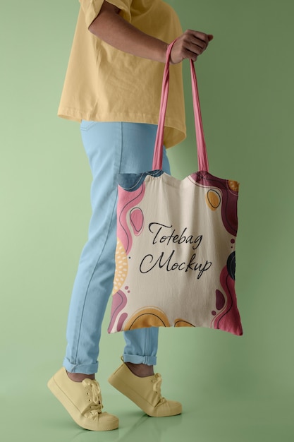 Side view of person holding tote bag mock-up