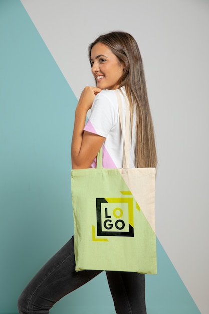 Side view of smiley woman holding bag