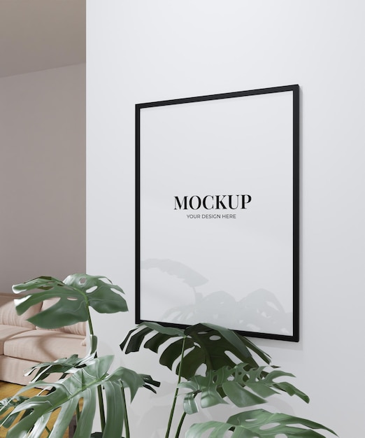 Simple frame mockup poster hanging on the white wall from side view with plant decoration