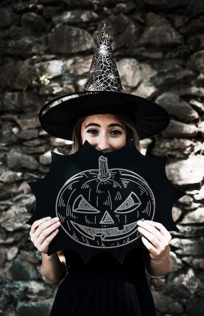 PSD sketch of a carved pumpkin and woman dressed as a witch