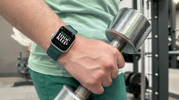 Smart watch mockup in gym with dumbbell psd template