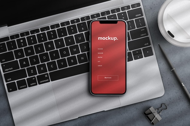 Smartphone app screen device mockup presentation on laptop keyboard business office concept flatlay