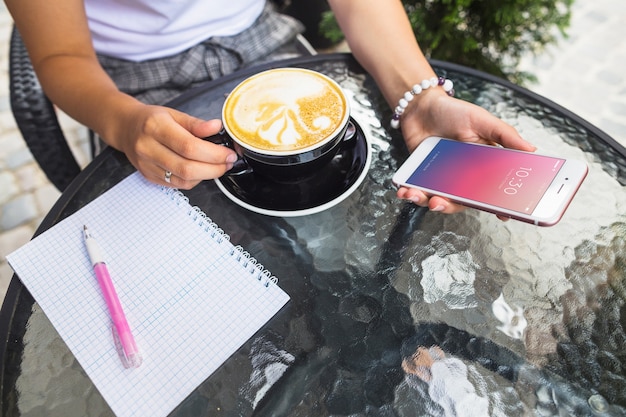 Smartphone mockup on table with cappuchino